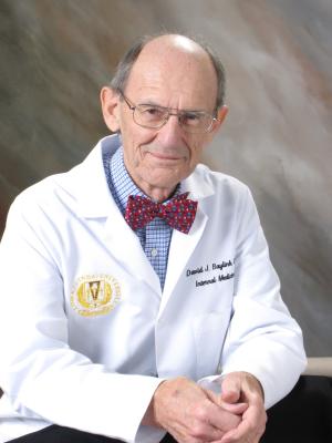 Dr. David J. Baylink in his white coat at Loma Linda University